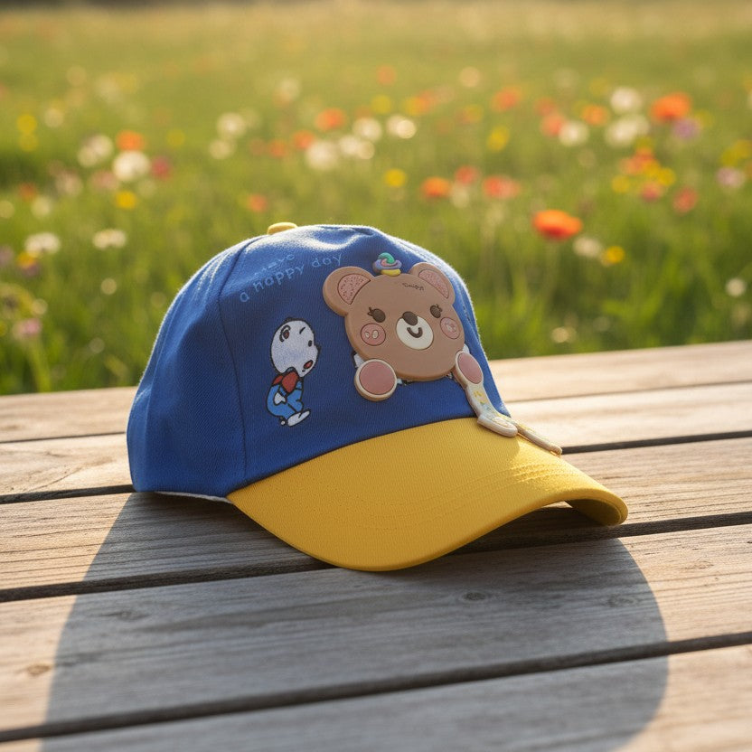 Mango Muffins blue cotton cap with yellow brim, featuring a 3D bear charm and "have a happy day" text.