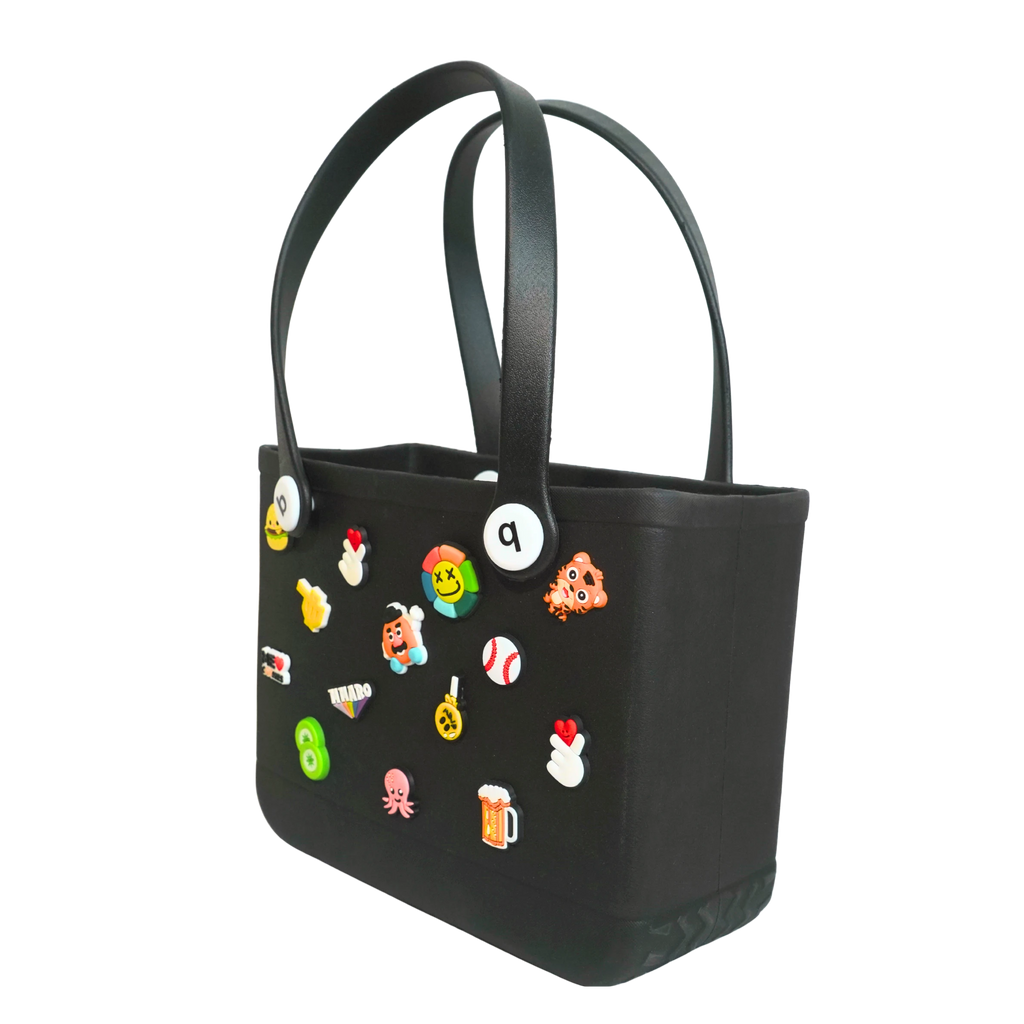 Mango Muffins black waterproof PVC tote bag decorated with colorful Jibbitz charms like an octopus and beer mug.