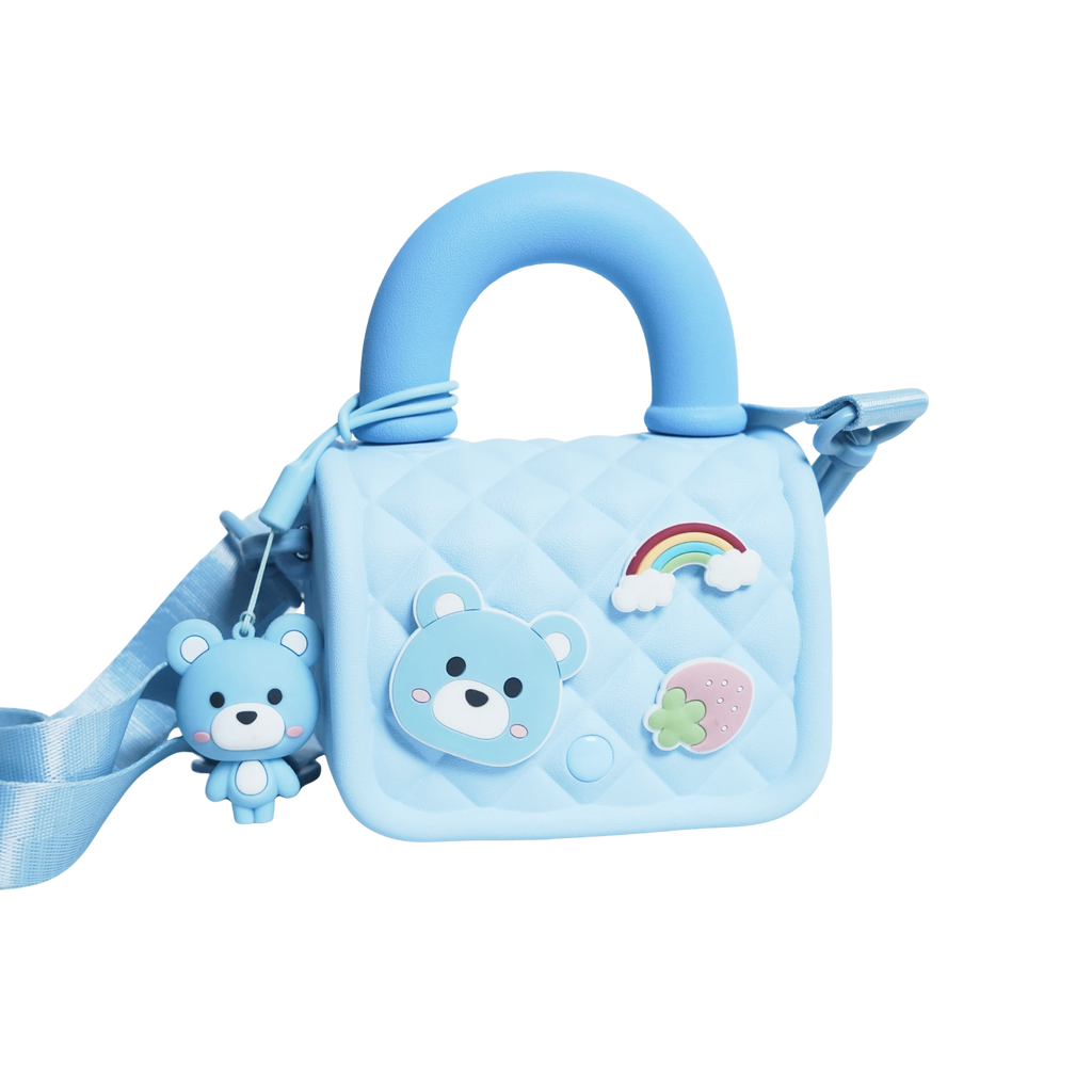 Mango Muffins light blue quilted sling bag with bear, rainbow, and strawberry appliques and a matching bear charm.