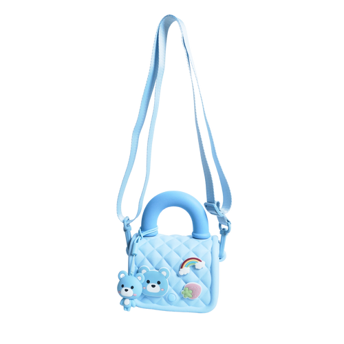 Mango Muffins light blue quilted sling bag with bear, rainbow, and strawberry charms. Adjustable strap.
