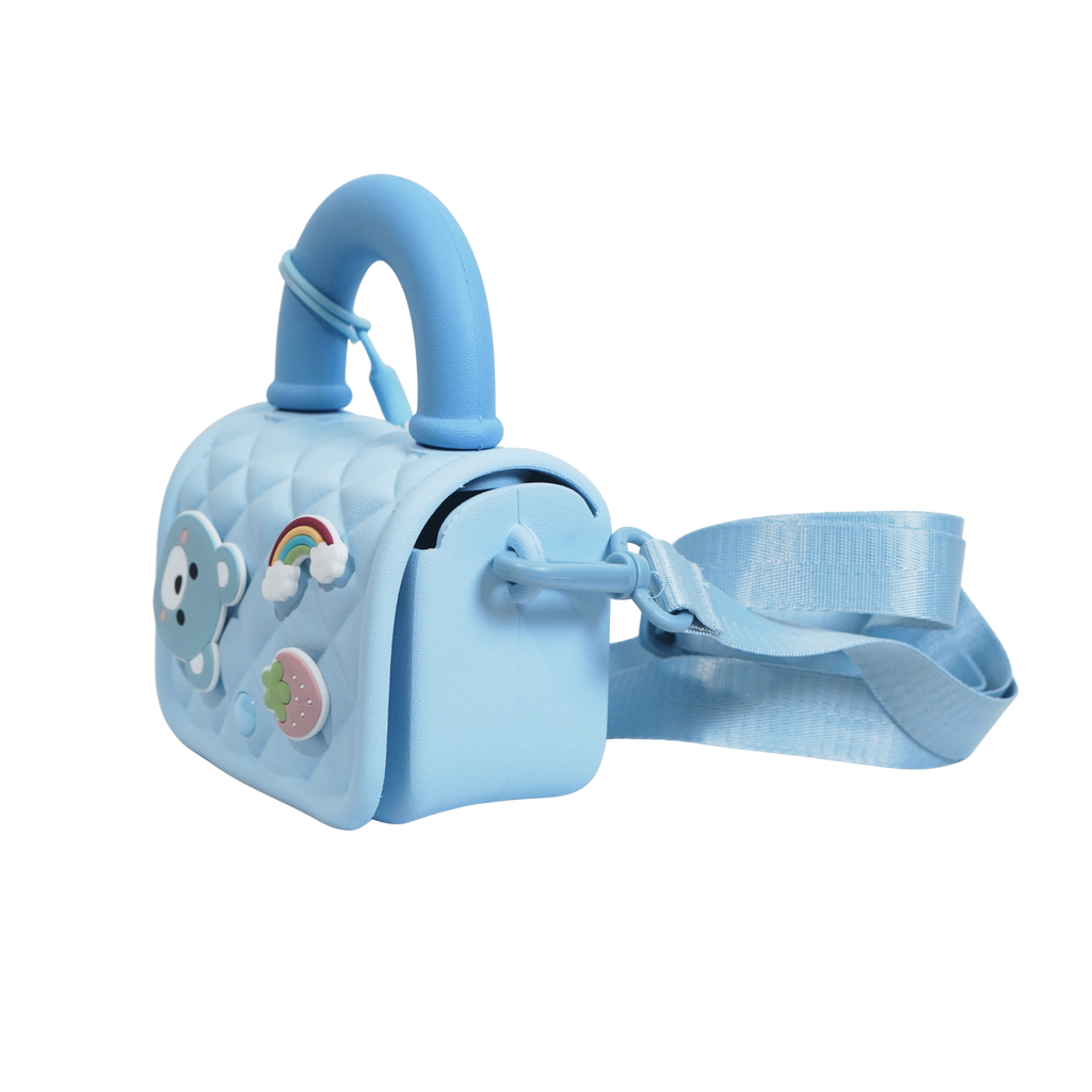 Mango Muffins light blue quilted sling bag with bear, rainbow, and strawberry charms. Adjustable strap.
