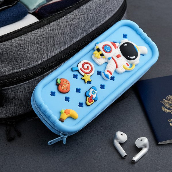 Light blue silicone pencil case by Mango Muffins with astronaut, rocket, lollipop, and banana charms. Features a zipper closure.