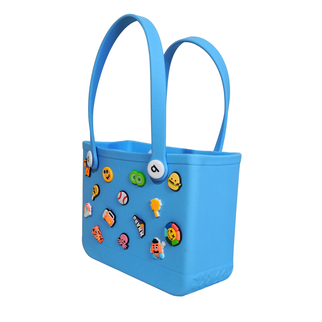 Mango Muffins blue waterproof PVC tote bag with fun Jibbitz-style charms and soft handles for kids.