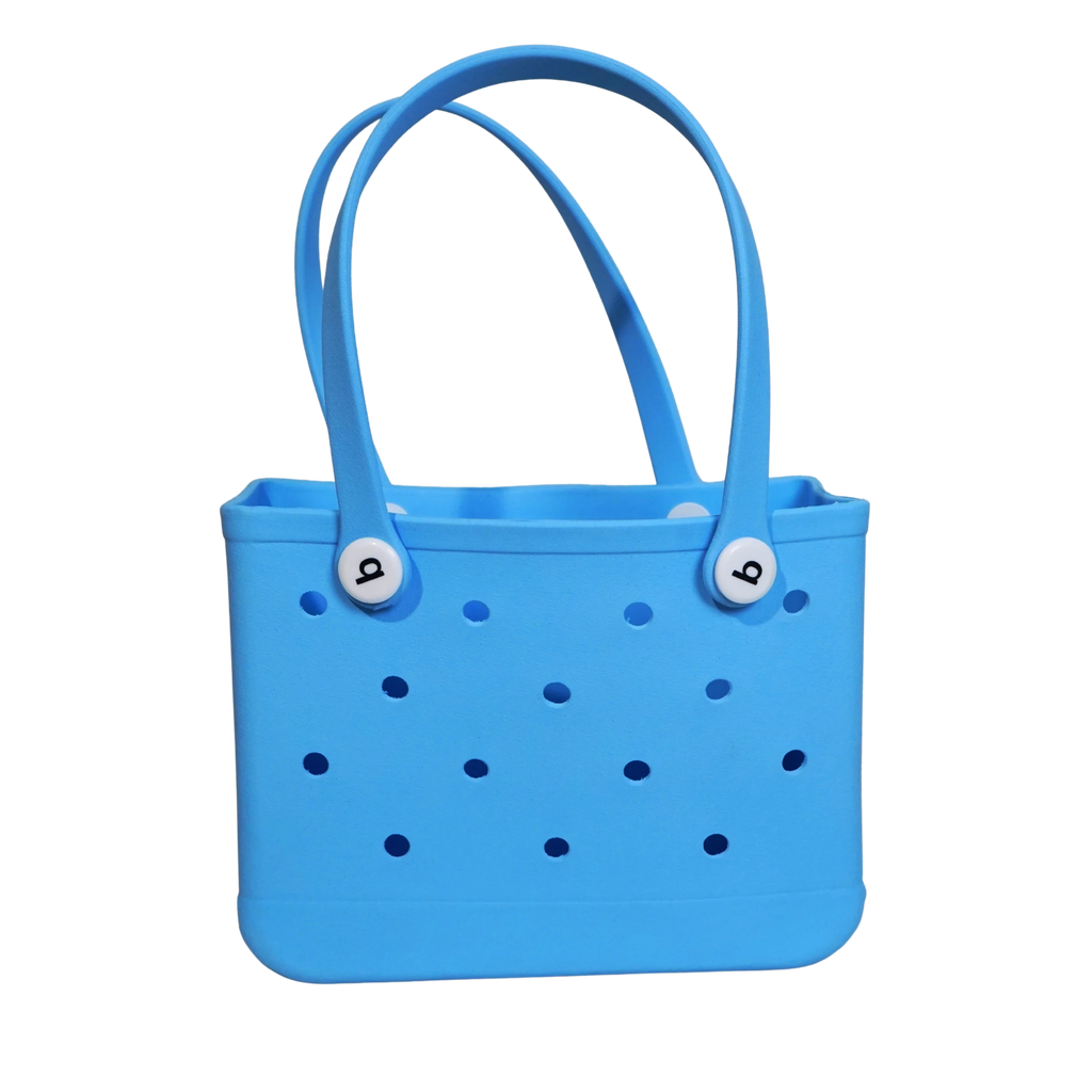 Mango Muffins bright blue waterproof PVC tote bag with polka dot cutouts and white logo buttons.