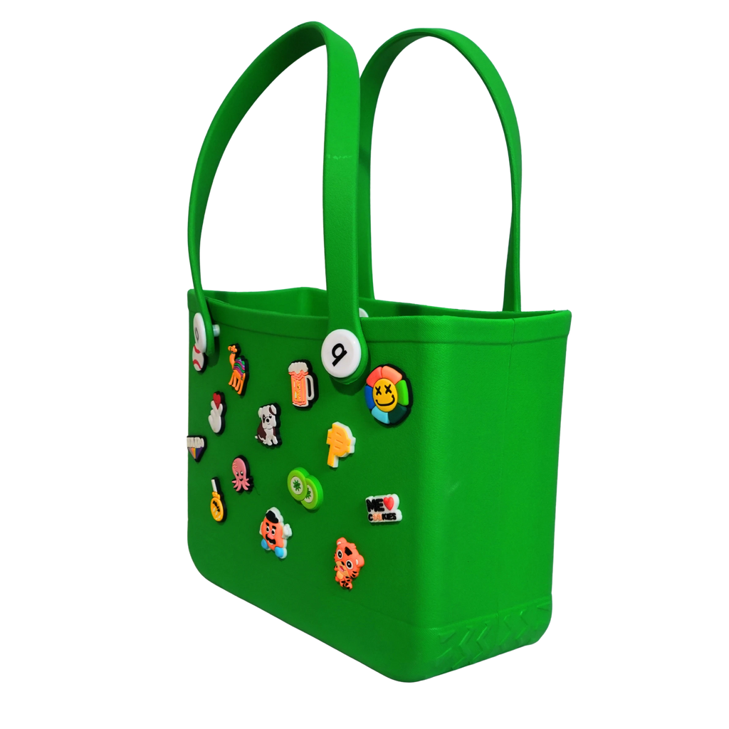Mango Muffins bright green waterproof PVC tote bag with colorful Jibbitz-style charms and soft straps. Perfect for kids.