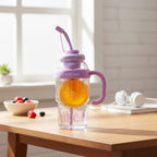 Mango Muffins Ice Cream Social Sipper tumbler with handle, straw, and orange slice. Purple and clear.