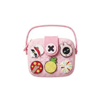Mango Muffins pink EVA sling bag for kids with customizable charms like a pineapple, mushroom, and bunny.