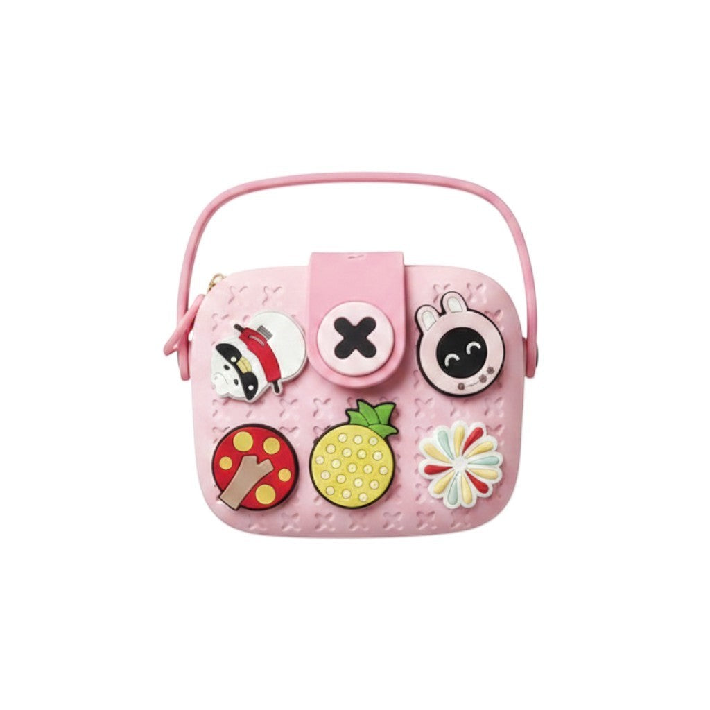 Mango Muffins pink EVA sling bag for kids with customizable charms like a pineapple, mushroom, and bunny.