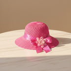 Mango Muffins pink woven cloche hat with polka dot ribbon and fabric flower accent.