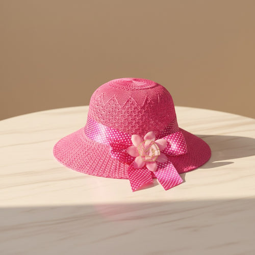 Mango Muffins pink woven cloche hat with polka dot ribbon and fabric flower accent.