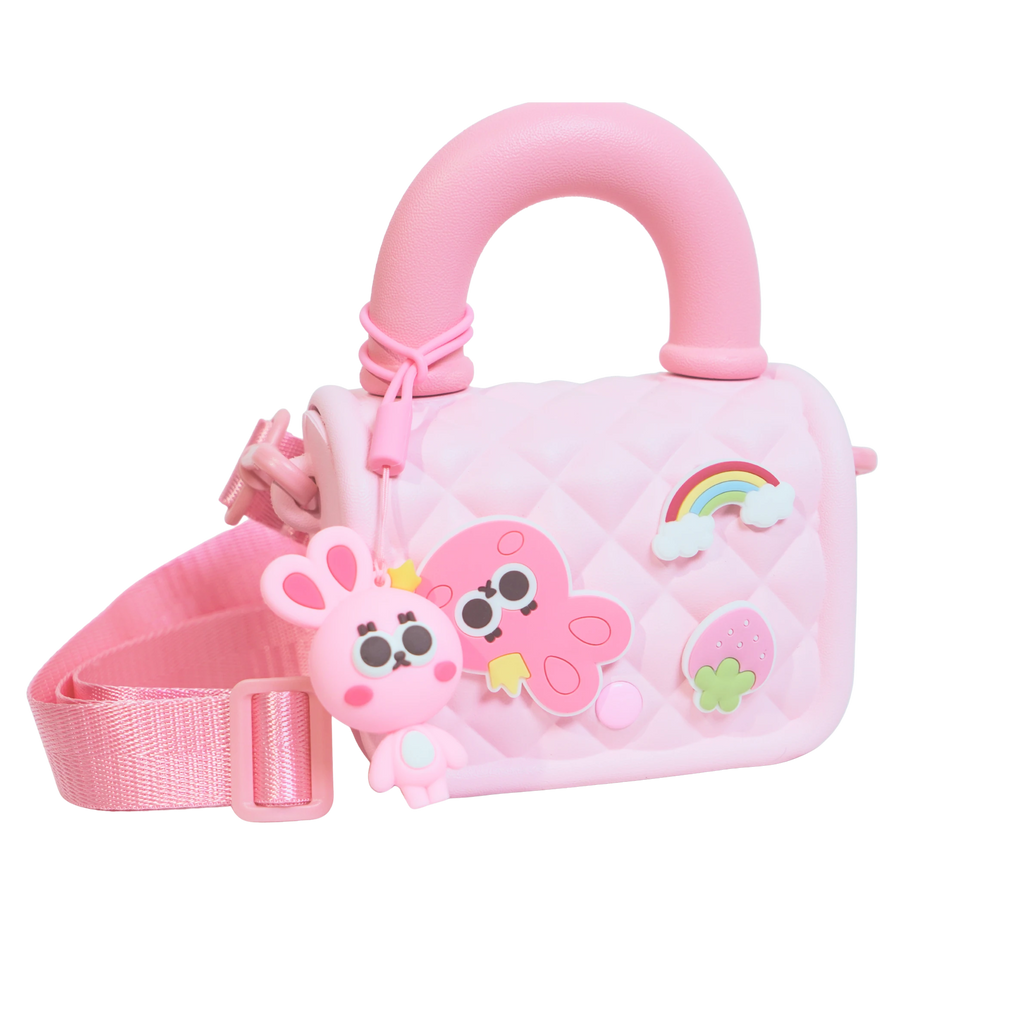 Mango Muffins pink quilted sling bag with cute bunny, octopus, rainbow, and strawberry charms. Adjustable strap.