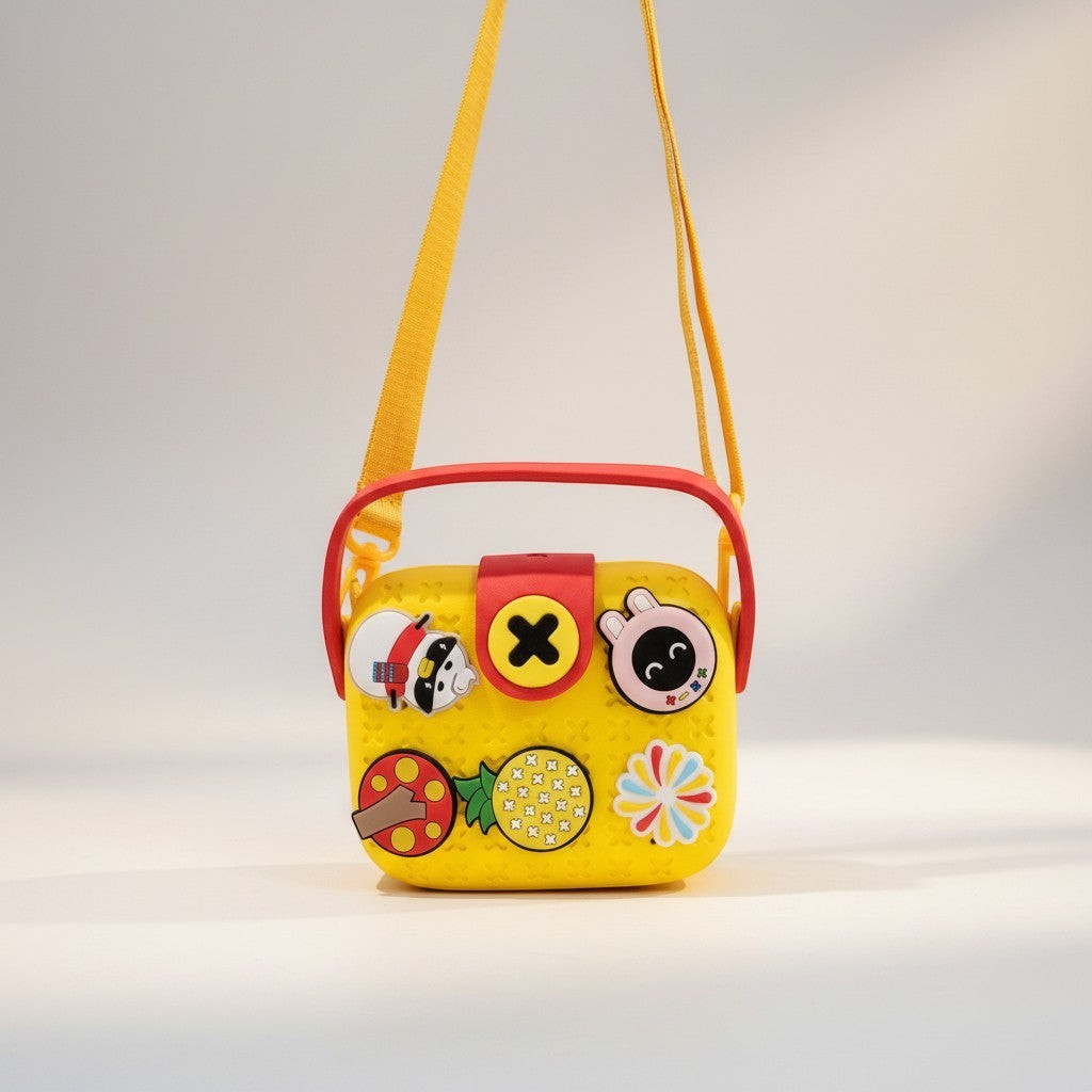 Mango Muffins yellow EVA crossbody sling bag for kids with red handle and yellow strap, featuring customizable charms.