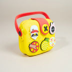 Mango Muffins yellow EVA sling bag for kids with red handle and colorful charms like a pineapple and bunny.