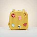 Mango Muffins yellow hard shell backpack with 3D charms: fish, ice cream, flower, acorn, panda, and car.